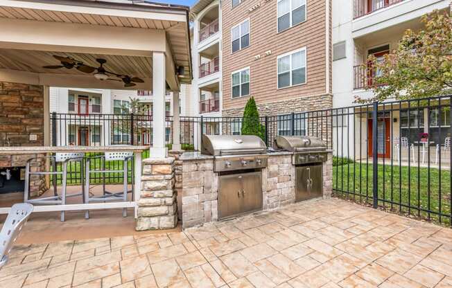 the preserve at ballantyne commons spacious outdoor patio with grill and stone wall