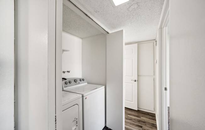 a white kitchen with a white stove and a white refrigerator