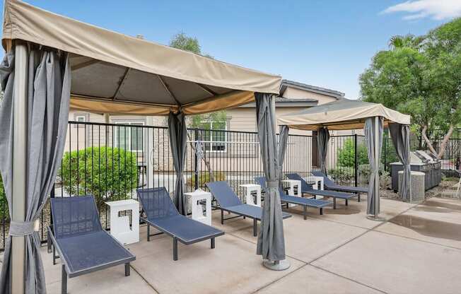 A sunny day at the outdoor seating area with blue chairs and beige canopies.