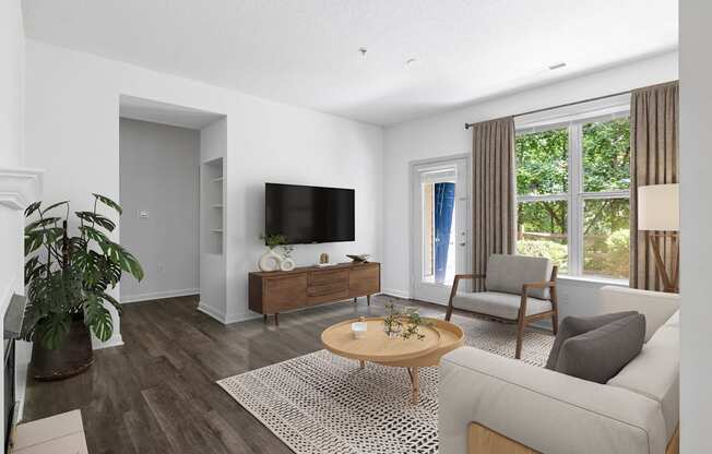 A living room with a grey couch, a wooden coffee table, and a flat screen TV.