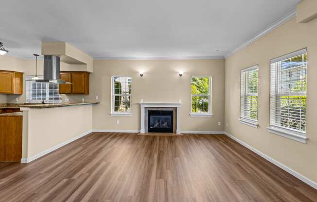 Little Tuscany Apartments & Townhomes - Fireplace in Living Room, Breakfast Bar, Wood Vinyl Plank Flooring - located in Olympia