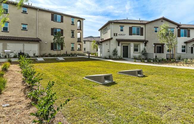 A grassy area in front of a building with a number 43337 on it.