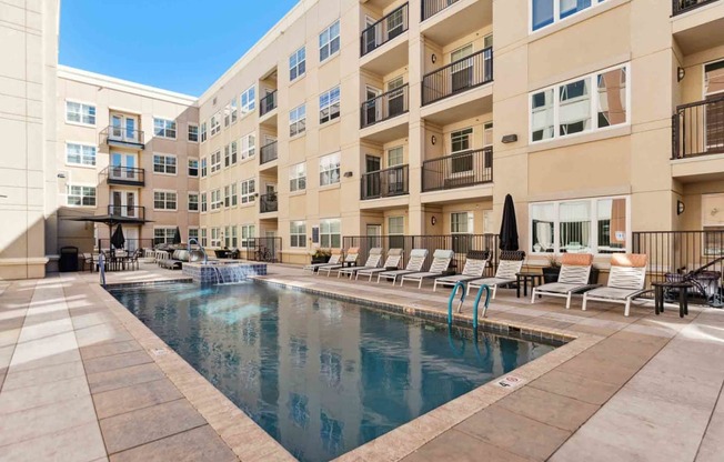 a swimming pool in front of an apartment building