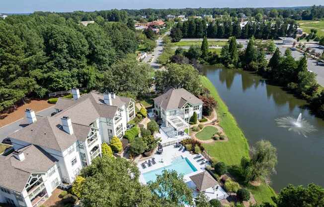 A large white house with a pool in the backyard.