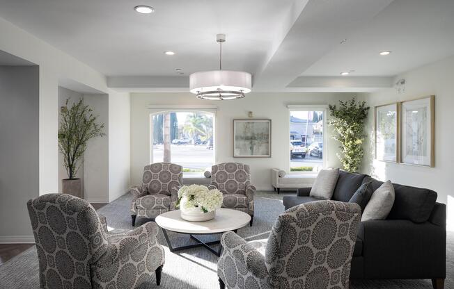 a living room filled with furniture and a large window