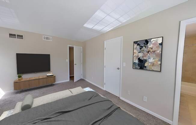 a bedroom with a large bed in front of a tv