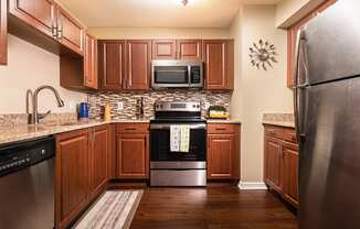 full kitchen with stainless steel appliances and wooden cabinets