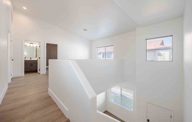 a view of a staircase in a home with white walls and wood floors