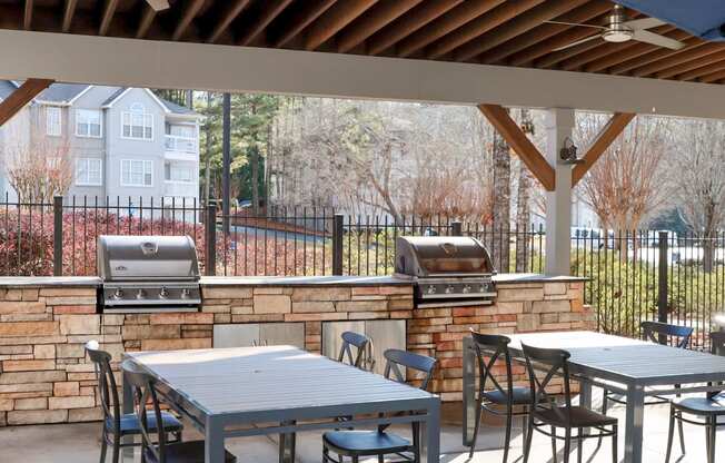 The Crest at Berkeley Lake grilling station with tables and seating located in Duluth, GA 30096