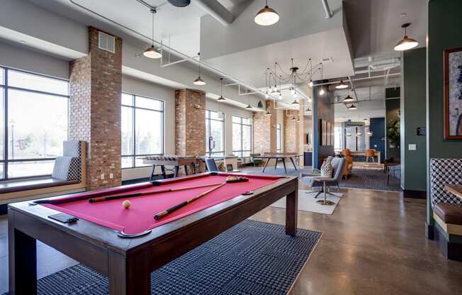 a pool table in the resident clubhouse at the bradley braddock road station apartments