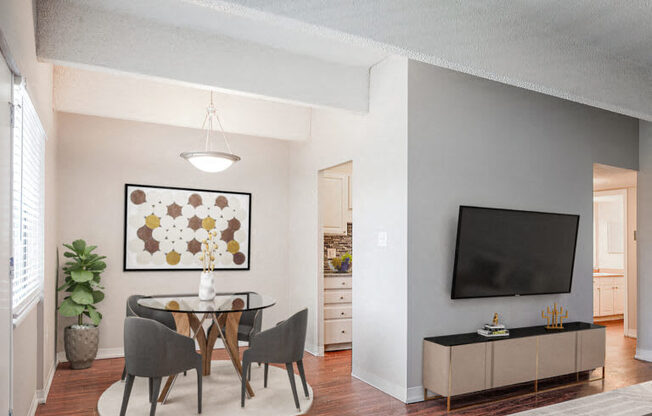 a living room with a table and chairs and a television