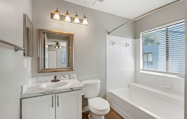 Model bathroom with white vanity at Huntington Place in Sarasota, Florida.