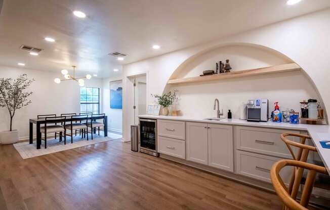 the kitchen and dining room of a house with a table and chairs