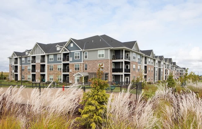 A row of houses with a grassy area in front.