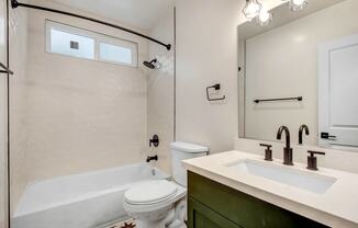 a bathroom with a sink toilet and a bath tub