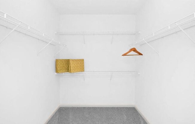 a white room with two shelves and a hanger on the wall