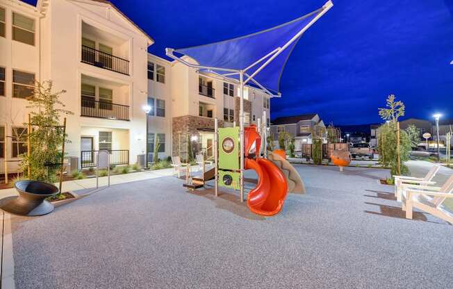 Playground area at night with bright blue skies at Morgan Ranch Apartments, Morgan Hill