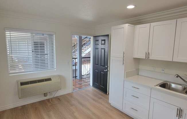 One bedroom apartment kitchen area with white cabinets at the Atrium Apartments in San Diego, CA.