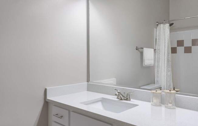 A white bathroom sink under a mirror.