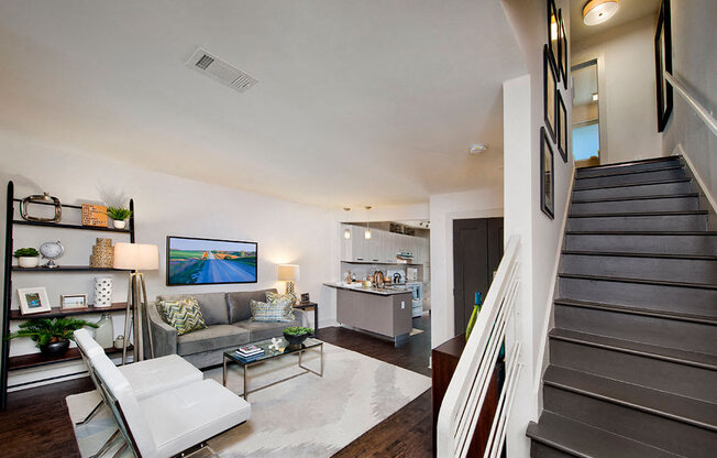 A living room with a white chair and a grey couch.