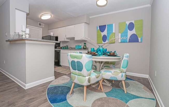 A cypress dining room with a table and chairs in the middle of the room at The Marq in Shreveport, LA
