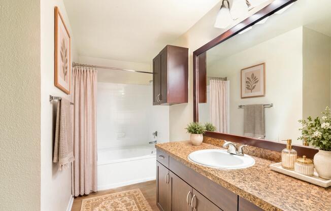 Designer bathrooms with double vanities and large mirrors.