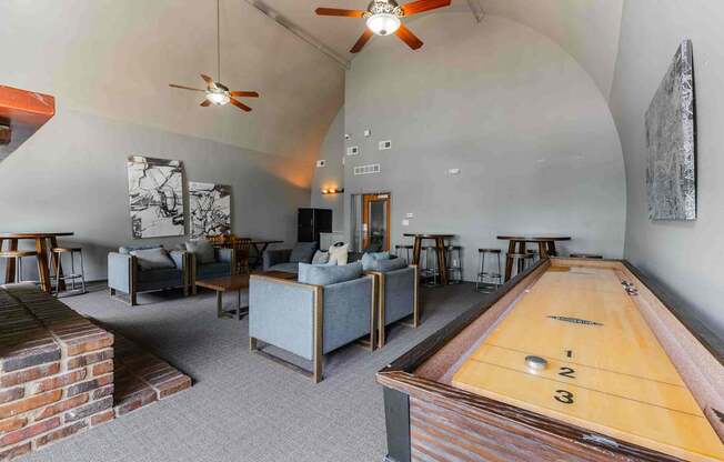 A room with a pool table and a shag carpet.