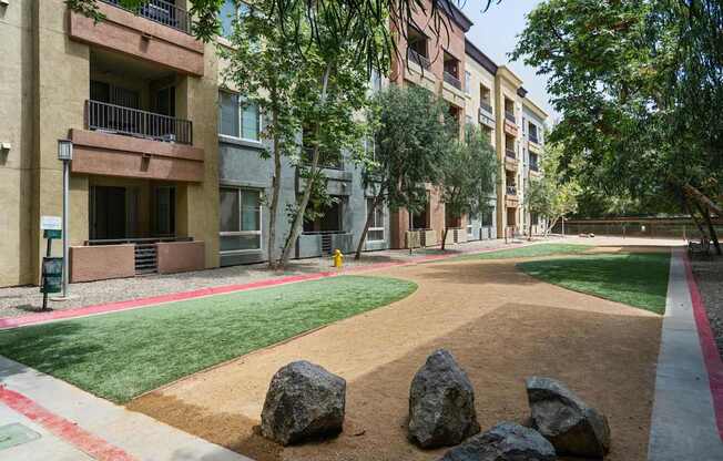 A large rock sits in the middle of a dirt path at The Kitt at Warner Center Apartments, Woodland Hills, CA