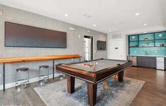 a game room with a pool table and a bar