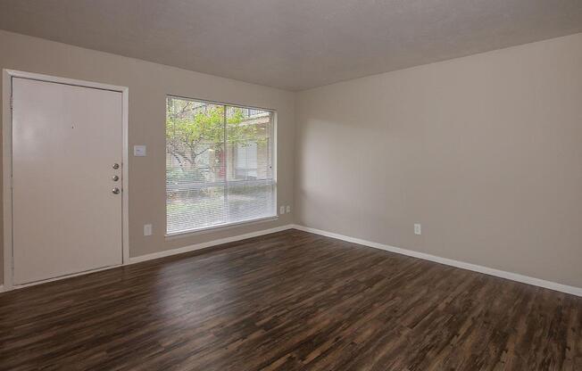 vacant living room with wooden floors