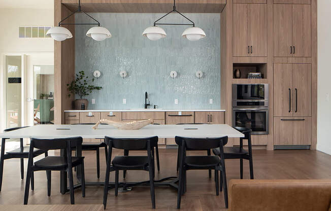 A modern kitchen with a glass backsplash and wooden cabinets.