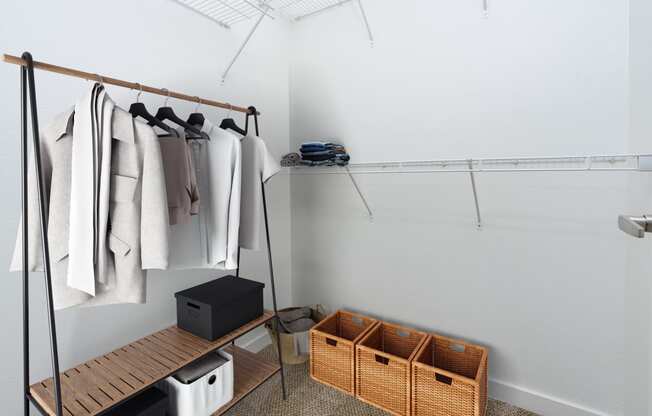 a walk in closet with wooden shelves and baskets