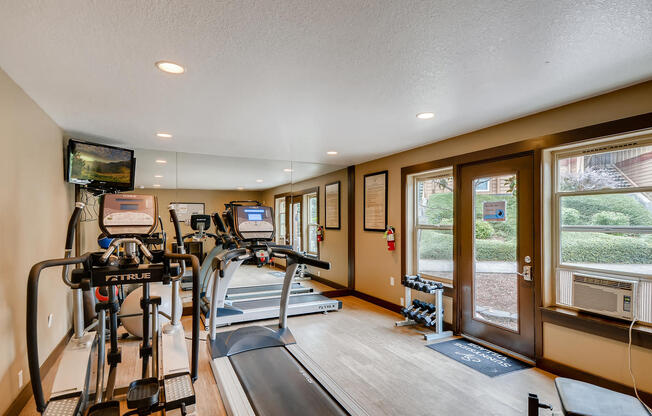 Apartments in Happy Valley for Rent - Expansive Fitness Center Featuring Various Gym Equipment