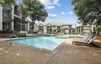 a resort style pool and lounge chairs at Jefferson Creek in Irving, TX