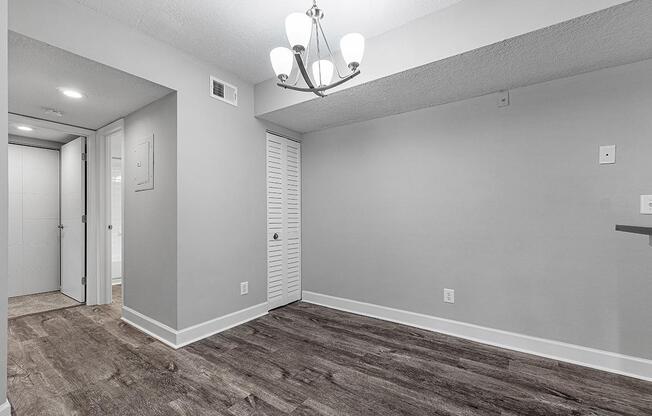 a large empty room with a sink and a mirror