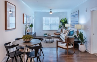 a living room with a couch and a table and chairs