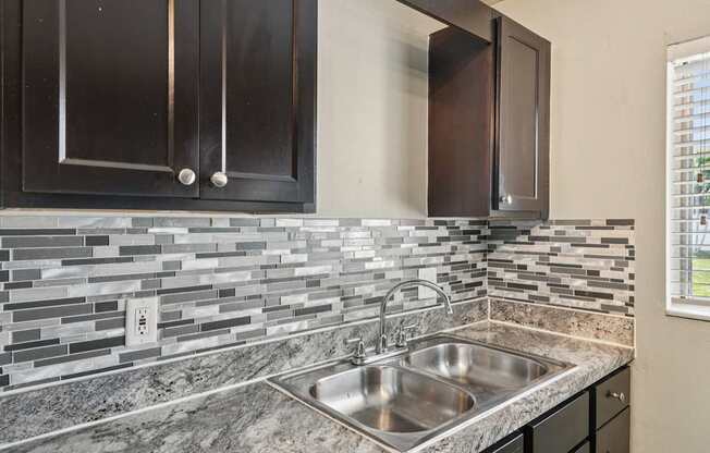 A kitchen with a sink and cabinets.