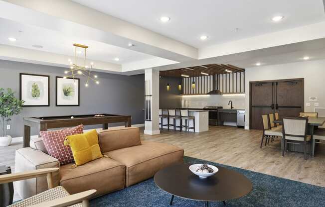 a living room with a couch table and chairs