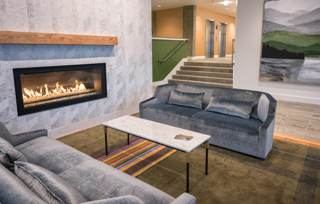 Indoor fireplace with sofas in lobby lounge