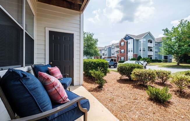 a couch on a porch in front of an apartment building