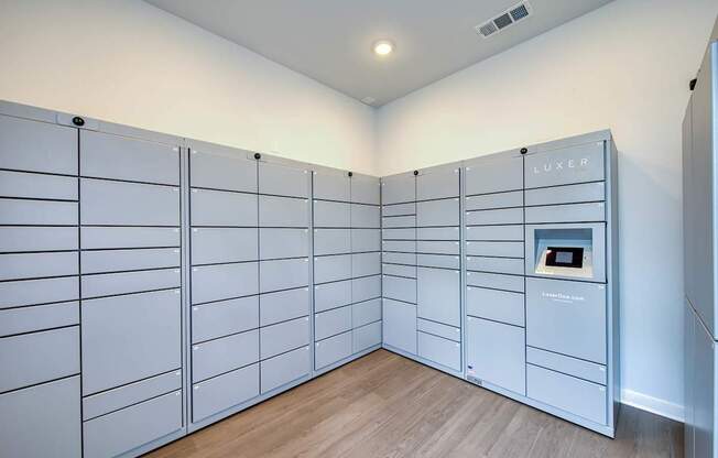 A room with a wall of lockers and a sign that says "LUXER".