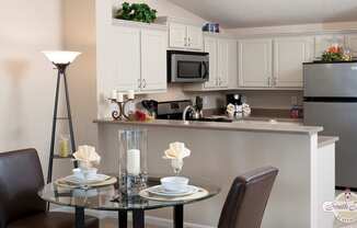 a kitchen and dining room with a table and chairs