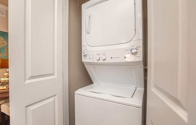 A white washing machine in a small laundry room.