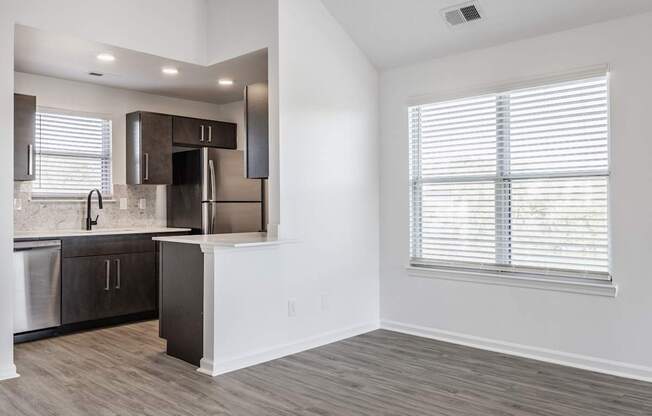 A kitchen with a stainless steel refrigerator, dishwasher, and oven.