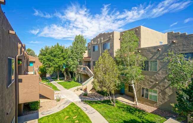 A sunny day in a courtyard surrounded by buildings.