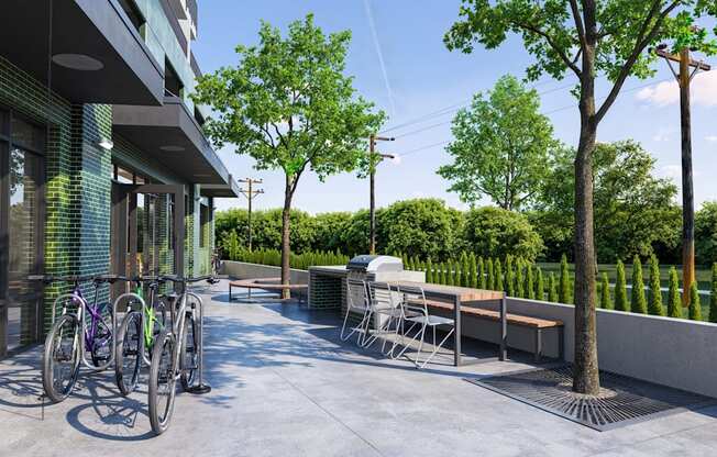 a patio with tables and bikes outside of a building at Link Apartments® CYKEL Apartments, Charlotte 