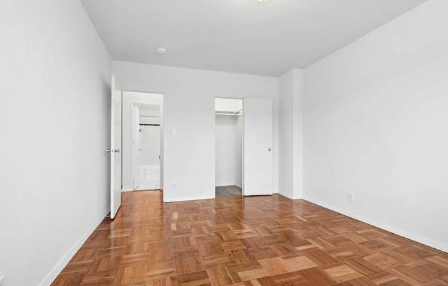 A room with wooden floors and white walls.
