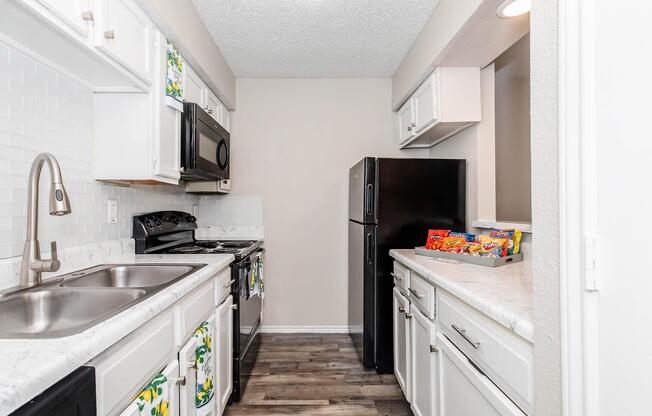 a kitchen with a stove sink and refrigerator