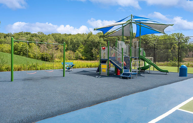 Community Playground with a Slide, Swing Set and Canopy at Elevate on Parkway Apartments, Minnesota