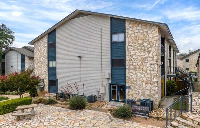 a house with a stone facade and a picnic table in front of it